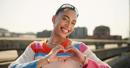 Face, heart hands and woman in city, support and kindness for peace, care and social media. New York, person and girl with symbol for love, outdoor and smile with portrait, gen z or review with emoji