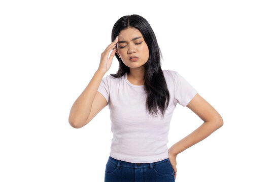 Young Asian woman suffering from headache and fatigue, touching her temple with eyes closed, expressing pain and stress, isolated on transparent background