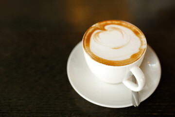cup of cappuccino coffee on the wooden table