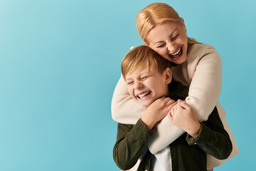 Joyful mother and son sharing a delightful moment of laughter and love against a vibrant backdrop