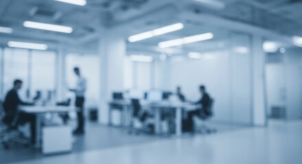 Fototapeta premium Blurred image of people working at desks in a modern office with bright lighting and large windows