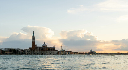 This photo, captured in March 2025, shows the majestic San Giorgio Maggiore in Venice, with its iconic dome reflecting on tranquil waters under a golden sunset.