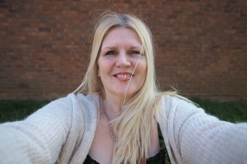 selfie portrait mature woman aged 50 plus British real people taking selfie smiling blonde hair 