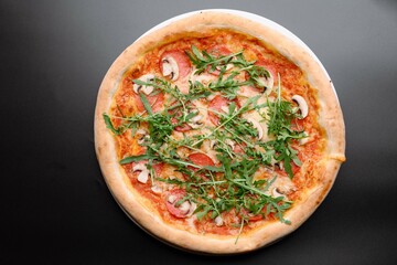 Delicious Pepperoni Pizza Topped with Fresh Arugula and Mushrooms