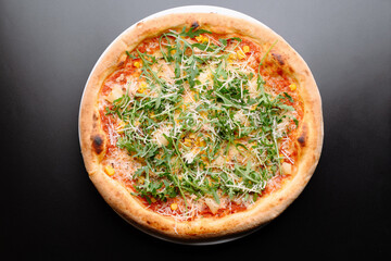 Delicious Fresh Pizza Topped with Arugula and Parmesan Cheese