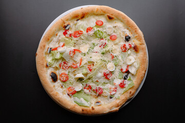 Delicious pizza topped with fresh vegetables and creamy sauce