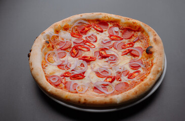Delicious pepperoni pizza topped with spicy chili and onions