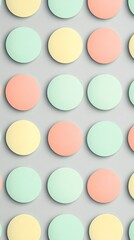 A pattern of mint green, coral, and yellow circles arranged neatly in rows on a pastel grey background
