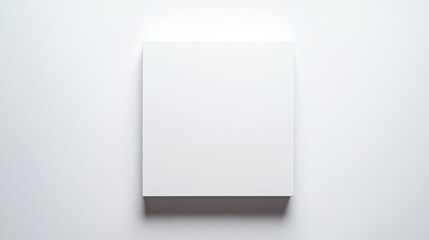 A blank canvas rests on a clean white surface, bathed in soft light. This minimalist setup encourages creativity and artistic exploration, perfect for painting or drawing