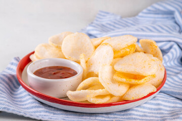 Crispy airy rice shrimp chips. Fragrant prawn crackers with sauce, traditional Asian fast food snack, junk food healthier alternative