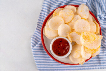 Crispy airy rice shrimp chips. Fragrant prawn crackers with sauce, traditional Asian fast food snack, junk food healthier alternative