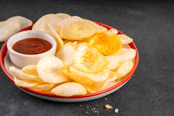 Crispy airy rice shrimp chips. Fragrant prawn crackers with sauce, traditional Asian fast food snack, junk food healthier alternative
