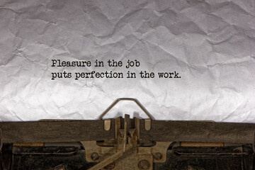 Pleasure in the job puts perfection in the work close up of a phrase being typed and centered on a...