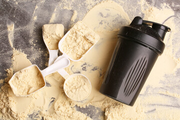 spoons with dry protein powder and a shaker