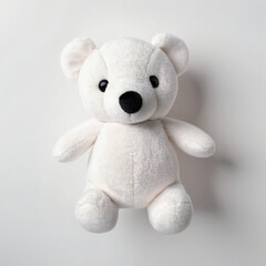 A white teddy bear on a white background. Top view.