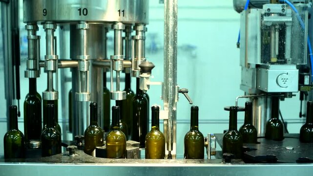 Wine bottle conveyor in action at a production facility showcasing glass bottle filling and packaging processes