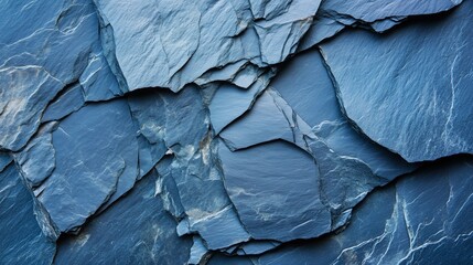 A stunning image focusing on dark blue slate rock texture characterized by its roughness and cracked layers forming a rugged surface
