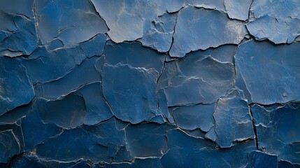 An artistic representation of dark blue slate rock texture showcasing rough and cracked layers that form a rugged surface
