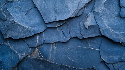 An intricate view of dark blue slate rock texture featuring rough and cracked layers that exemplify a natural and rugged surface