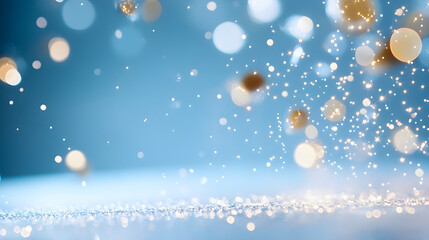 Sparkling golden particles floating in a soft blue background creating a magical atmosphere for celebrations and events, festive mood concept