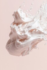 Soft cream splashes against pastel background, showcasing smooth