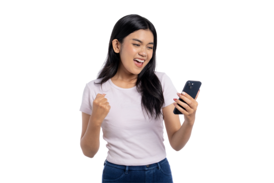 Excited young Asian woman celebrating victory while looking at her smartphone, isolated on transparent background