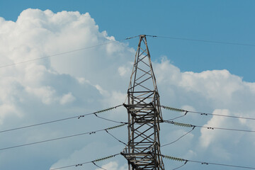 Power lines against the sky and clouds.
