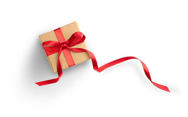 Present or gift box wrapped in brown craft paper and red ribbon on white background. Top view