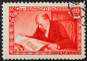 RUSSIA - circa 1957: A postage stamp printed in the USSR depicts Vladimir Lenin Ulyanov reading the Pravda newspaper, 40th anniversary of the Great October Revolution, Lenin Series, circa 1957.