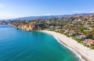 Aerial View of Serene Beach and Cliffs Along Coastal Landscape