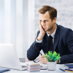 Stressed, tired businessman or having headache hold hand his cheek, in corporate black jacket use laptop at office workplace desk. Portrait square image - pessimistic fall thinking, ill business man