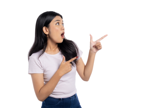 Surprised young Asian woman pointing to the side with excitement, isolated on transparent background