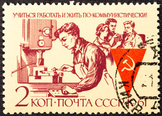RUSSIA - CIRCA 1961: Stamp printed in the USSR shows communist labor team Publicizing Communist...