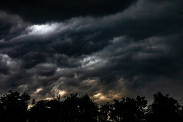 Storm clouds over tree. Dark Cloudscape before storm raining.