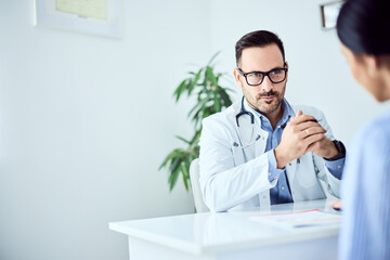 Male Doctor Communicating with Patient in a Modern Comfortable Medical Office