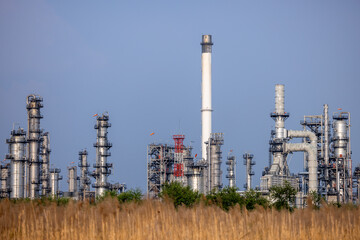 Oil and gas refinery industrial factory plant with blue sky background at oil and gas refinery zone, Business oil and gas industrial plant, Oil and gas refinery petrochemical plant industrial.