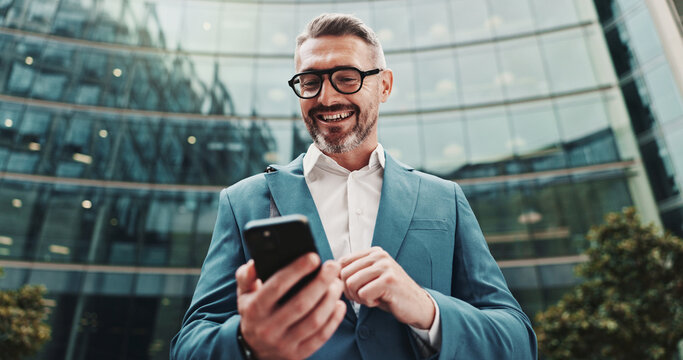 Business, smile and man in city, cellphone and internet with social media, communication and texting. Mature person, low angle and employee in street, smartphone or digital app for email and message