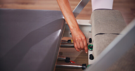 Fitness, pilates and hands of person with machine in class for exercise, practice and training. Prepare, start and athlete in gym with reformer equipment set up for health, wellness and challenge