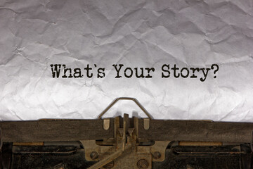 what is your story close up of a phrase being typed and centered on a sheet of paper on an old vintage mechanical typewriter.