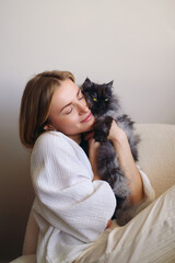 Tender moment at home young woman affectionately holding and embracing fluffy cat portraying warmth emotional bond and peaceful domestic comfort in cozy environment.