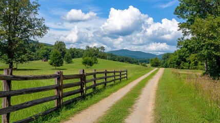 A peaceful countryside landscape with a wooden fence and a dirt road winding into the distance.