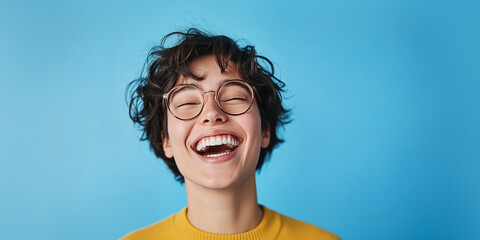 Happy non-binary person with diastema against blue background