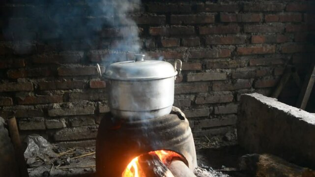 Traditional cooking with a stove made of clay and a hot pot boiling water