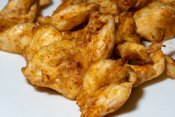 A pile of chicken pieces with a lot of seasoning on them