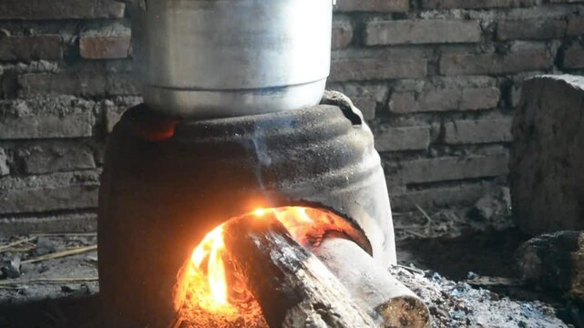 Traditional cooking with a stove made of clay and a hot pot boiling water