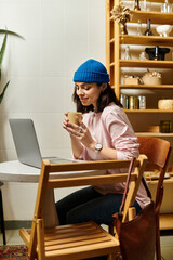 Freelancer enjoying coffee while working remotely in a modern cafe