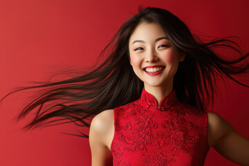Studio portrait of beautiful smiling CHINESE woman in RED dress on RED solid background