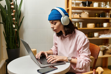 Young woman engaging in remote work at a cozy modern cafe setting