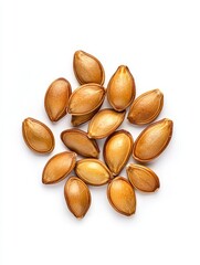 Obraz premium Close up view of roasted pumpkin seeds scattered on a white background. The seeds are light brown and appear dry and roasted.