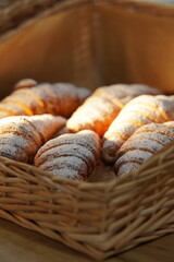 Freshly baked croissant sprinkled with powdered sugar
